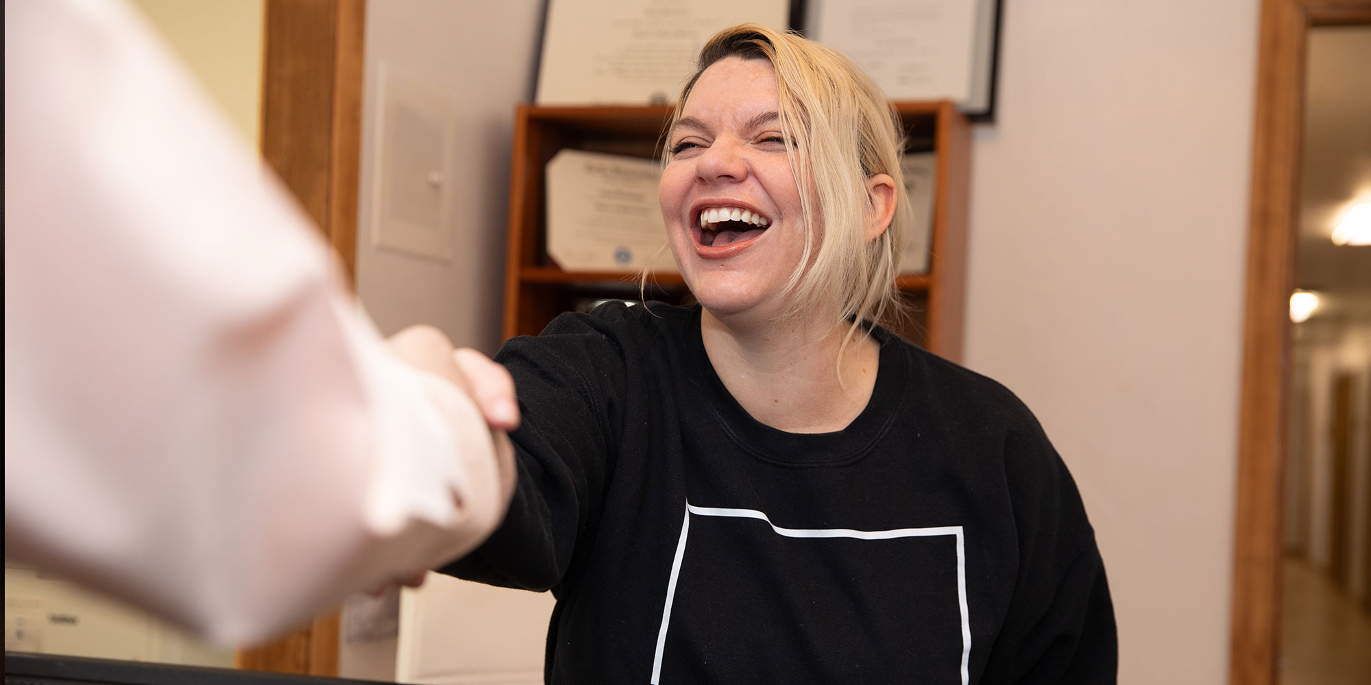 team member shaking patients hand