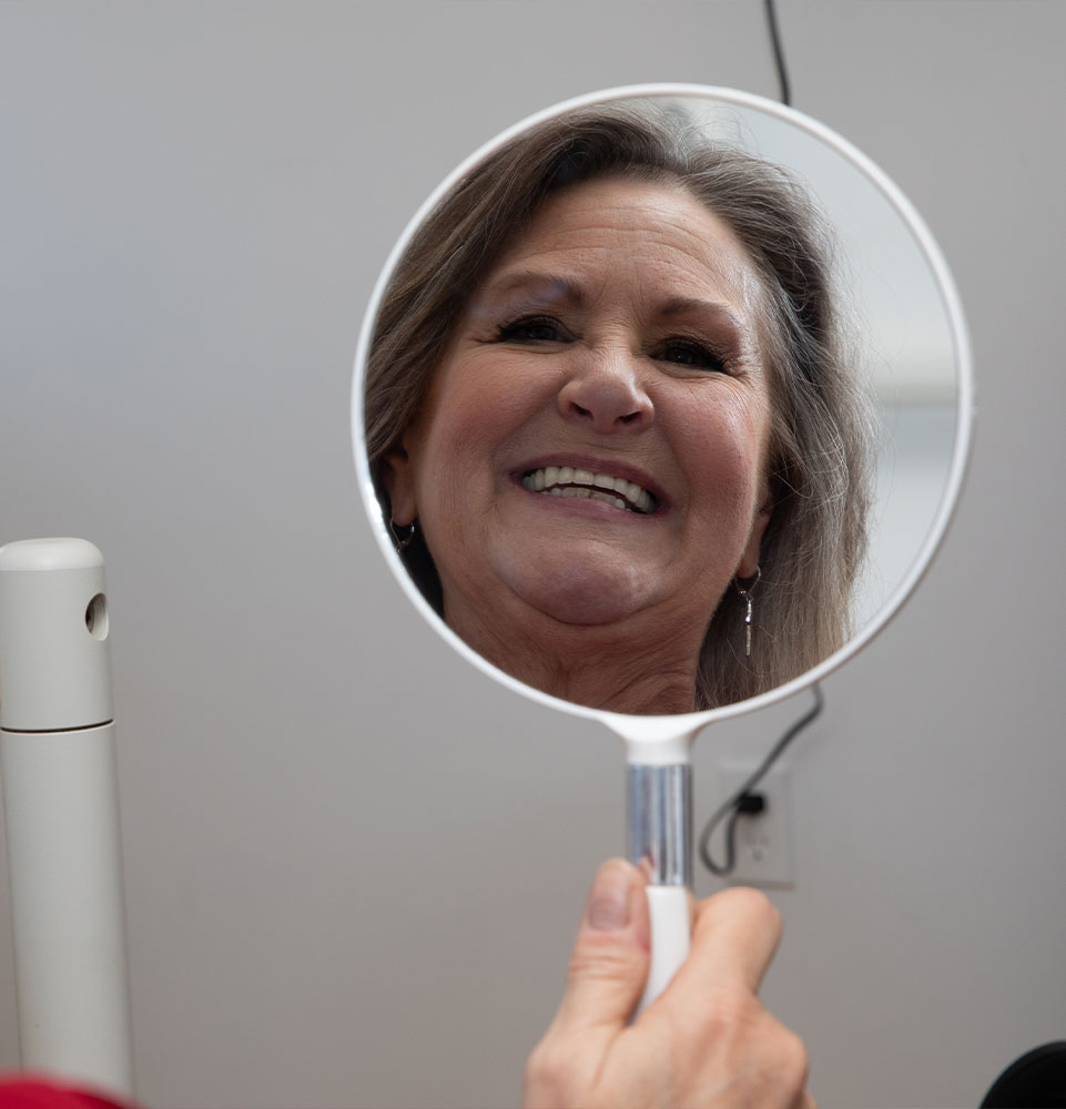 patient smiling to mirror