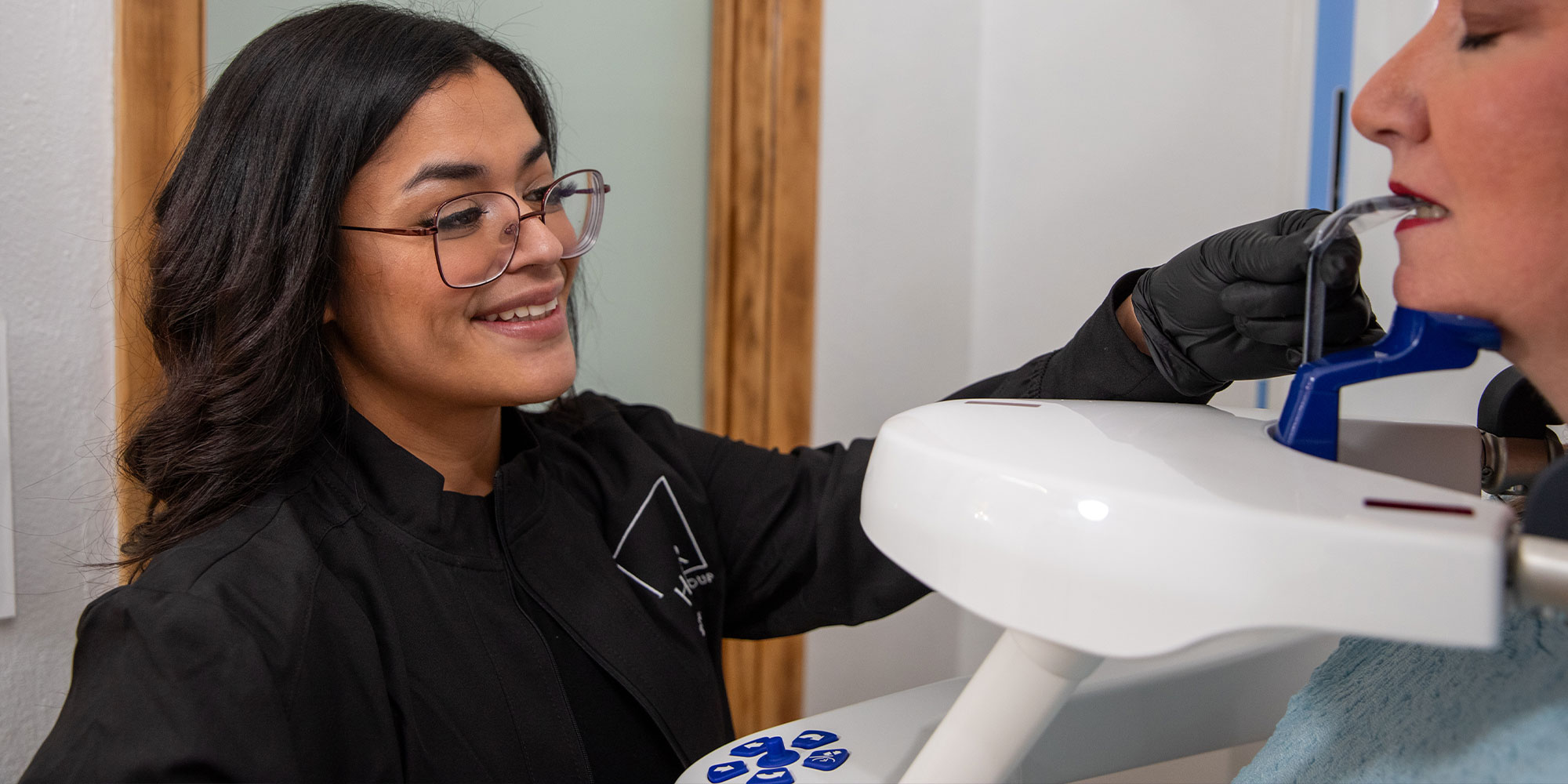 team member preparing patient for dental x-ray