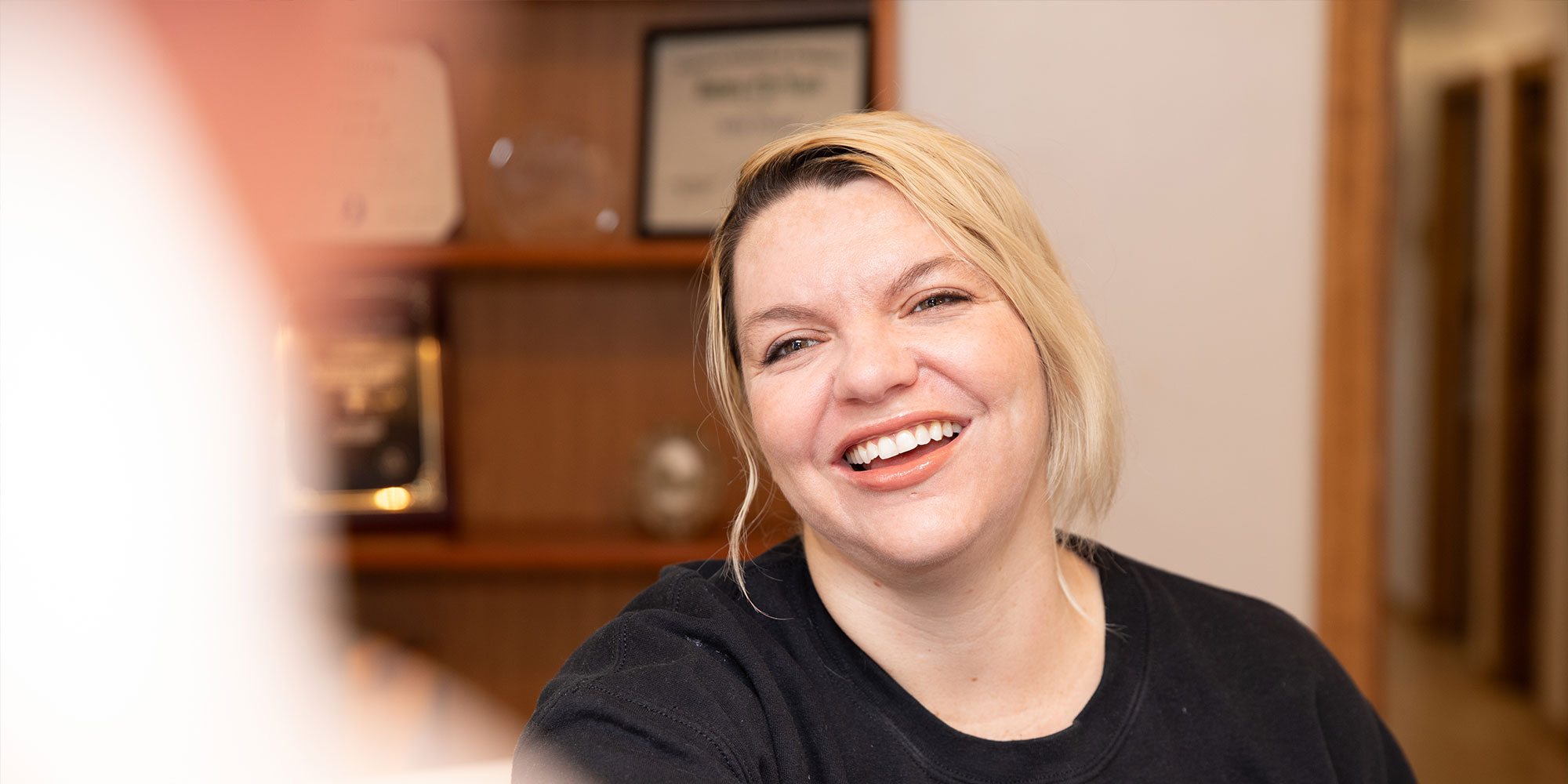 team member greeting a patient into dental office