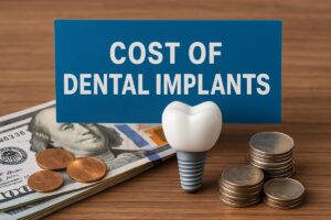 A photo of a dentist explaining tooth implant pricing to a patient while pointing to a digital display of different implant options. The dentist is wearing a white coat and the patient looks engaged and thoughtful. No text on the image.